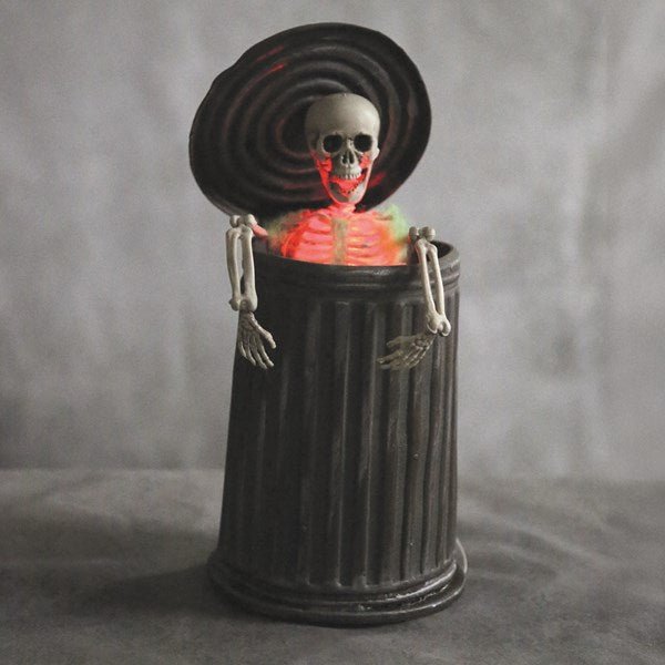 Motion-activated Halloween dustbin skeleton with red LEDs


