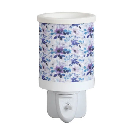 Lilac floral plug in wax melt burner with a blue and purple floral pattern and an on/off switch on the plug base.