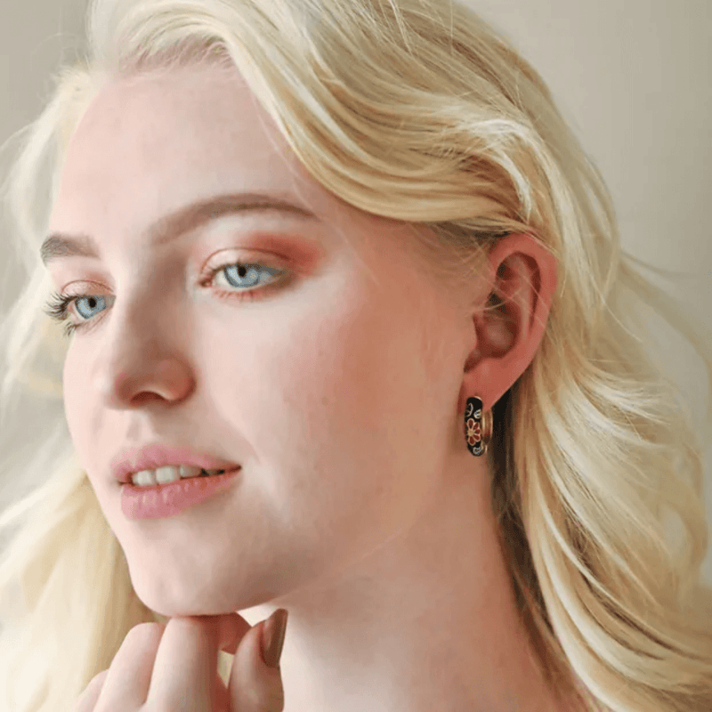 Model wearing Lisa Angel black cloisonné floral hoop earrings