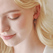 Lifestyle view of Lisa Angel black cloisonné hoop earrings being worn