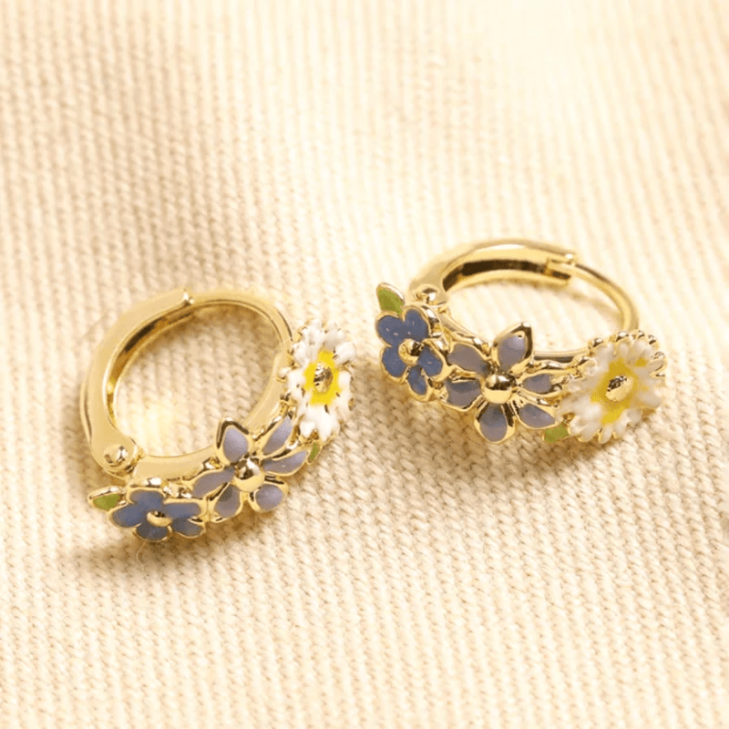 Pair of Lisa Angel gold huggie hoop earrings with blue purple and white enamel flowers