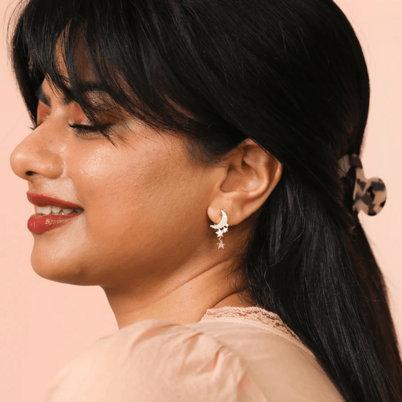 Model wearing Lisa Angel gold celestial moon and dangling star earrings