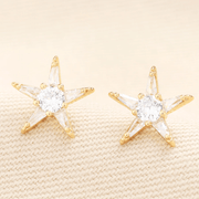 Close-up of Lisa Angel gold star stud earrings with cubic zirconia crystals