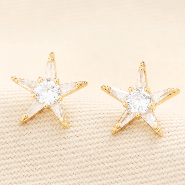 Close-up of Lisa Angel gold star stud earrings with cubic zirconia crystals