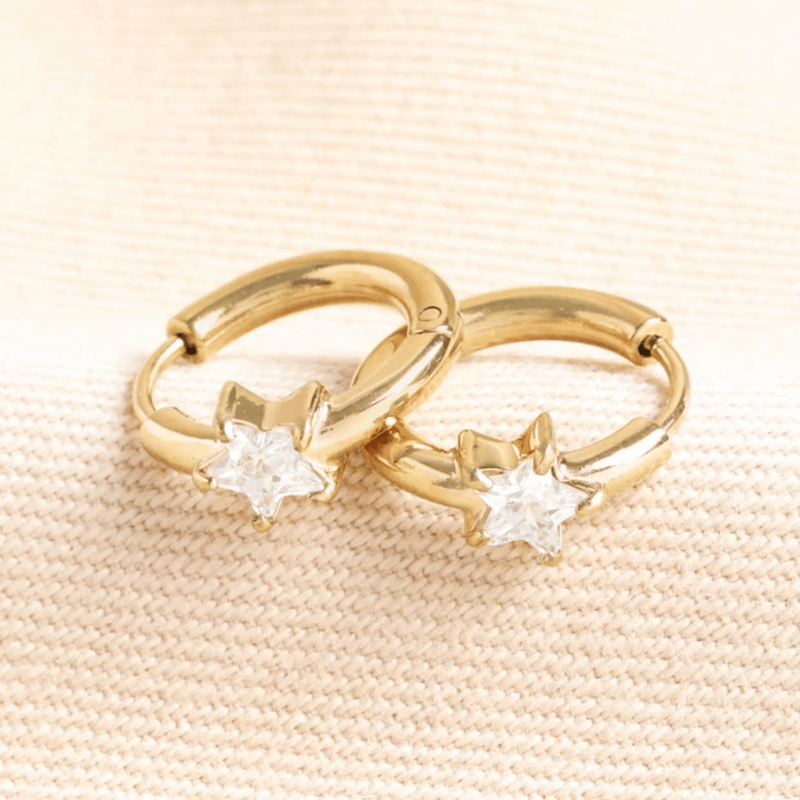 Pair of Lisa Angel gold huggie hoop earrings with clear crystal stars