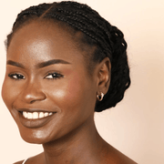 Model wearing petite Lisa Angel gold crystal star huggie hoop earrings