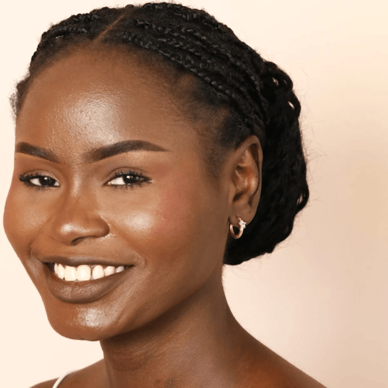 Model wearing petite Lisa Angel gold crystal star huggie hoop earrings