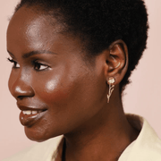 Model wearing Lisa Angel gold wildflower drop earrings