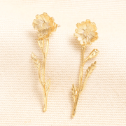 Pair of gold wildflower drop earrings with textured flowers stems and leaves