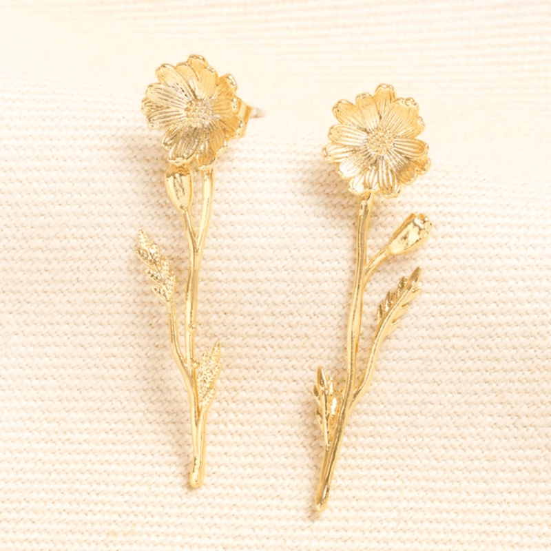 Pair of gold wildflower drop earrings with textured flowers stems and leaves