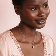 Model wearing the Lisa Angel gold necklace with a small green enamel frog pendant