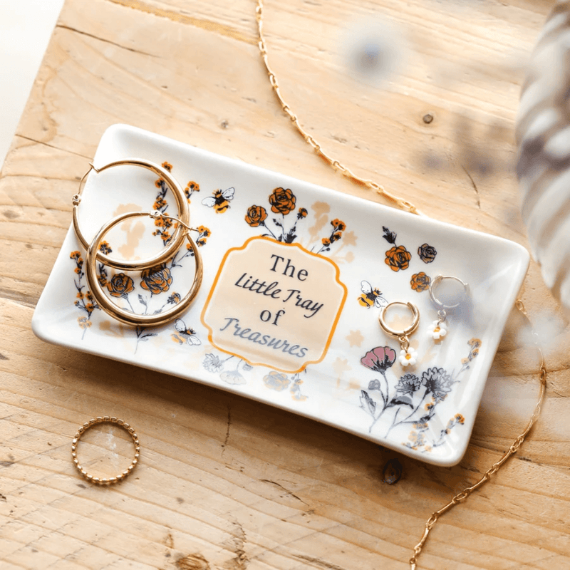 Lisa Angel ceramic trinket dish holding gold hoops, rings and small earrings