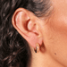 Lisa Angel chunky gold huggie hoop earrings with crystal stars worn in ear