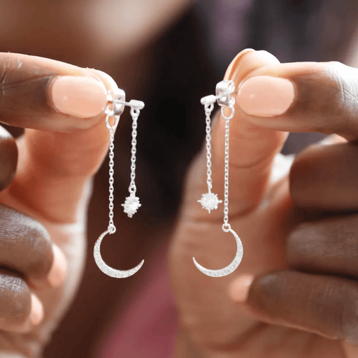Close-up of Lisa Angel crystal star and moon earrings showing the layered silver chains