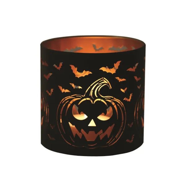 Lit jack-o’-lantern wax melt burner with bats glowing warmly

