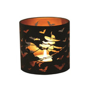 Glowing witch-themed wax melt burner with tealight inside

