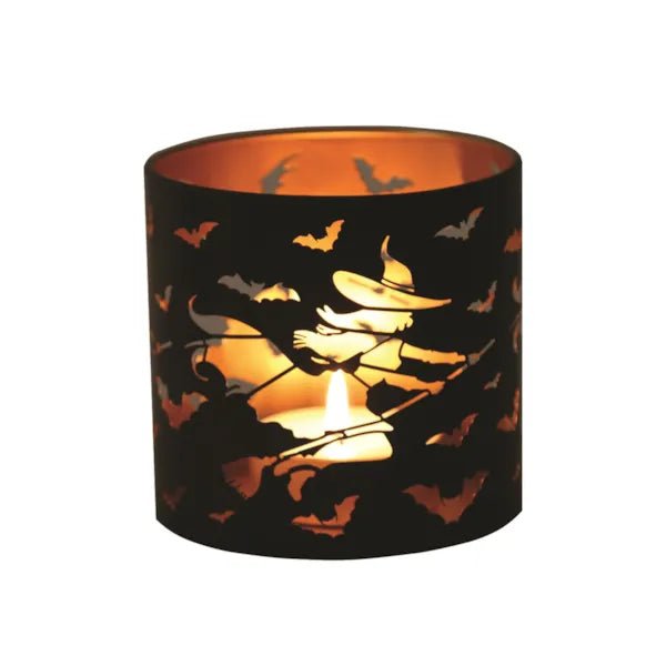 Glowing witch-themed wax melt burner with tealight inside

