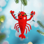 Lobster with fairy lights felt decoration hanging from a Christmas tree