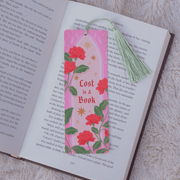 Lost In A Book floral bookmark with green tassel inside an open book