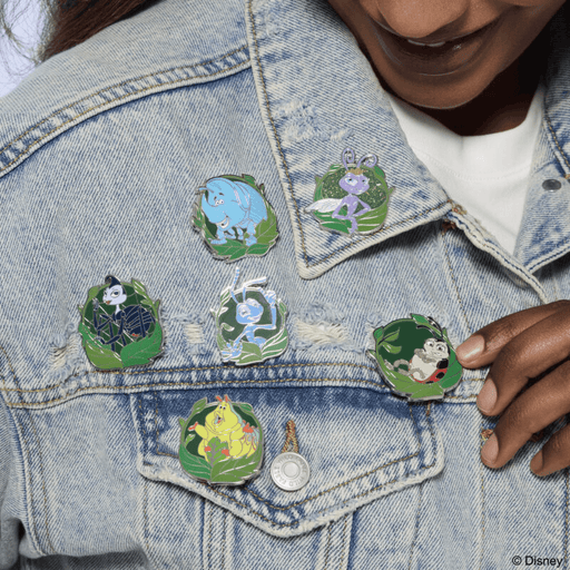 Loungefly A Bug’s Life mystery enamel pins displayed on a denim jacket