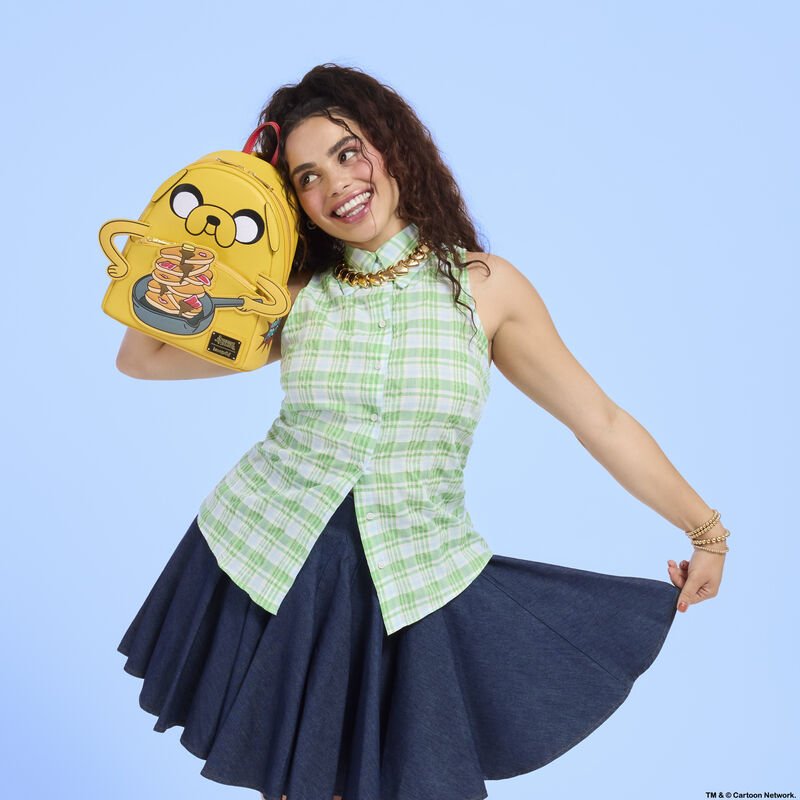 Model holding the Loungefly Adventure Time Jake backpack with playful pancake design