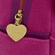 Close-up of the Loungefly Barney mini backpack showing the gold heart zip pull with Barney branding and plush fabric texture.