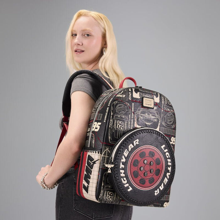 Model wearing the Loungefly Cars Lightning McQueen backpack over one shoulder