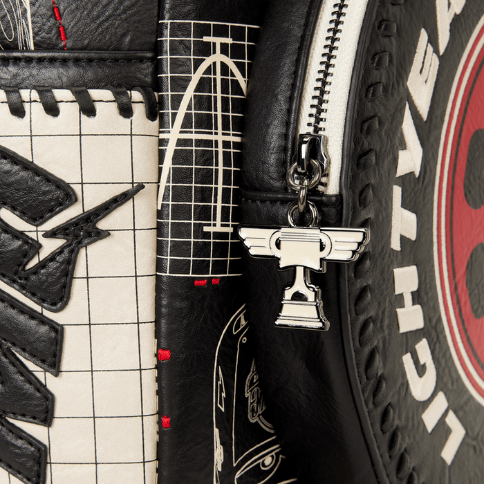 Close-up of Piston Cup trophy zip pull on the Loungefly Cars Lightning McQueen backpack