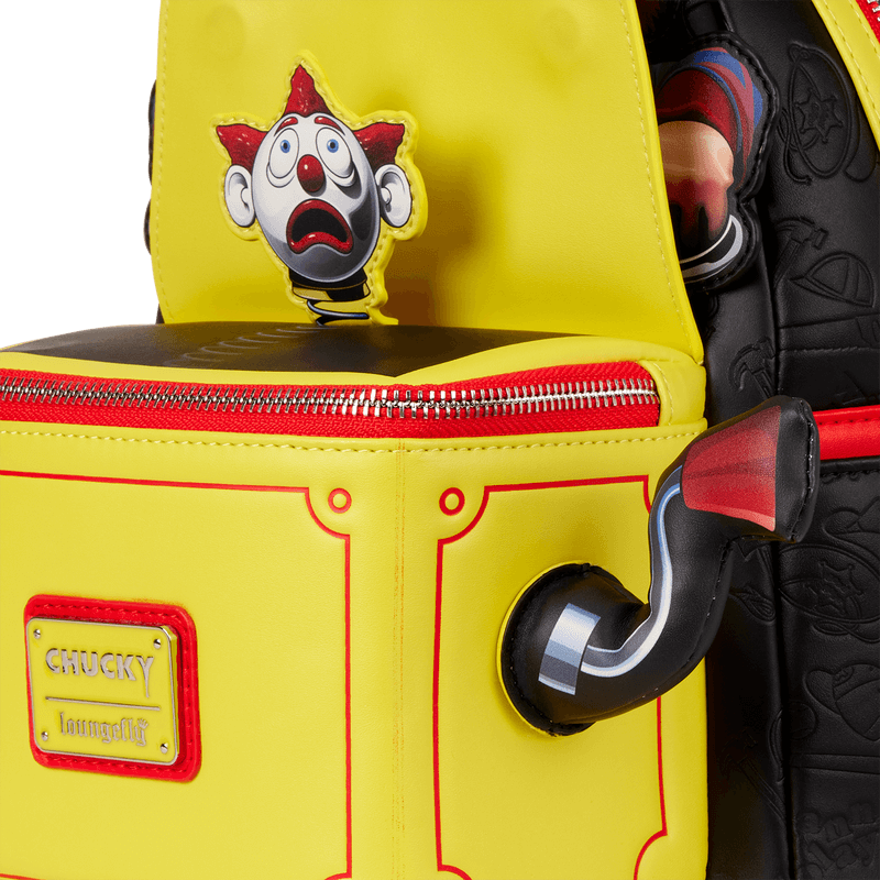 Close-up of crank handle and clown figure on Loungefly Chucky pop-up mini backpack
