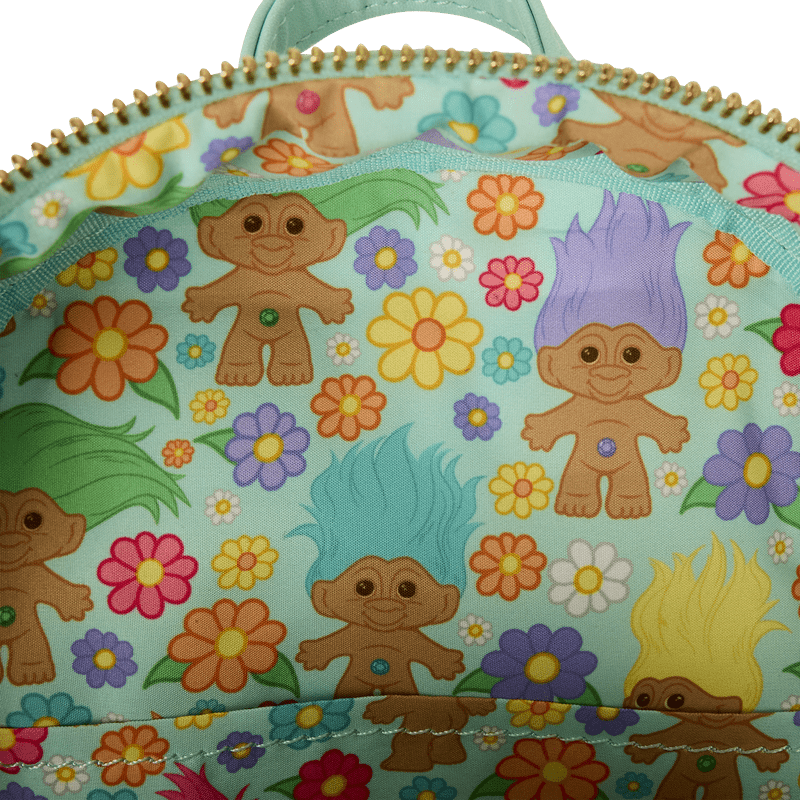 Interior lining of Loungefly Trolls backpack decorated with colourful Trolls and floral pattern