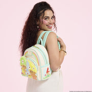 Model wearing the Loungefly Classic Trolls mini backpack with rainbow and fuzzy hair detailing