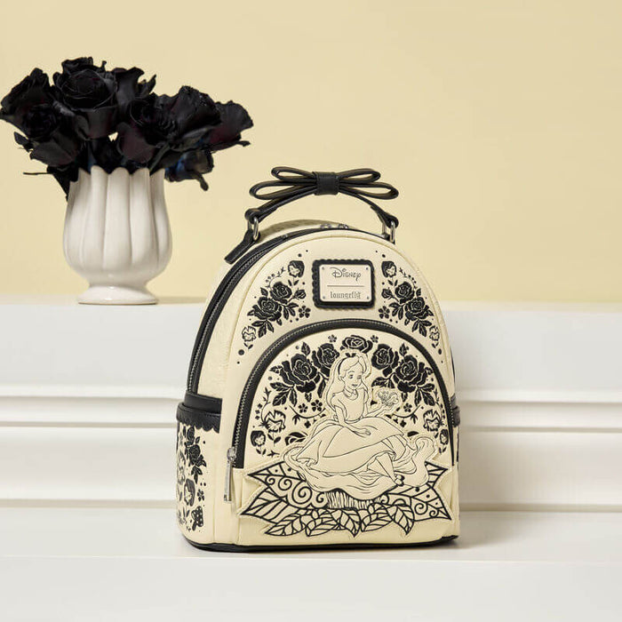 Loungefly Disney Alice in Wonderland Floral Mini Backpack displayed with black flowers