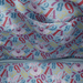 Close-up of the lining inside the Loungefly Disney Alice in Wonderland White Rabbit Handbag with colourful numbers, clock hands and White Rabbit faces