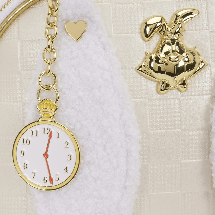 Close-up of the pocket watch charm and gold White Rabbit plaque on the Loungefly Disney Alice in Wonderland White Rabbit Handbag