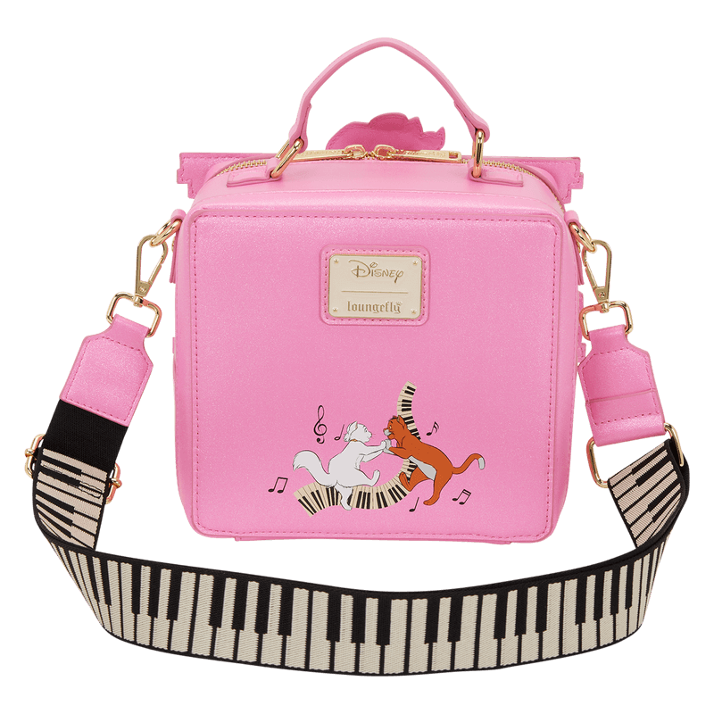Front view of the Loungefly Disney The Aristocats piano crossbody bag in pink with a piano key strap and cat characters dancing on the keys.