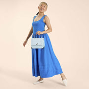 Model holding Loungefly Cinderella crossbody by crown handle, full length outfit