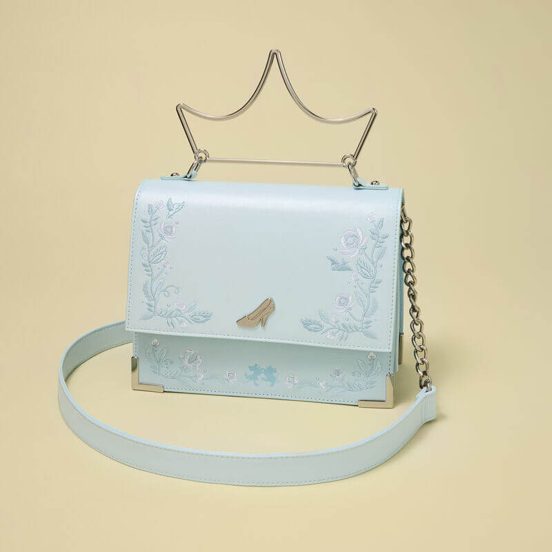 Studio shot of Loungefly Cinderella crossbody bag on neutral backdrop with strap