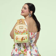 Lifestyle image of the Loungefly Disney Lady and the Tramp Pastel Tulip Mini Backpack worn by a model, featuring Lady and pastel tulip artwork