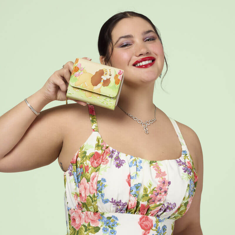 Model holding the Loungefly Disney Lady and the Tramp tulip pastel wallet
