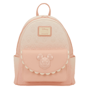 Front view of the Loungefly Disney Mickey & Friends All-Over Print Mini Backpack in pastel pink with embossed character faces and a Mickey front pocket