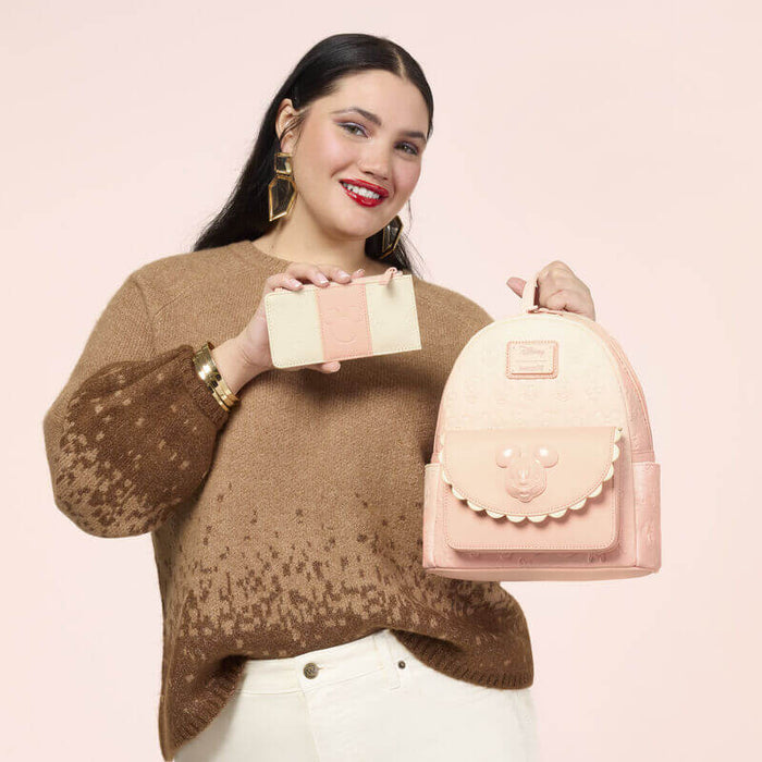 Lifestyle image of the Loungefly Disney Mickey & Friends All-Over Print Mini Backpack displayed with the matching wallet