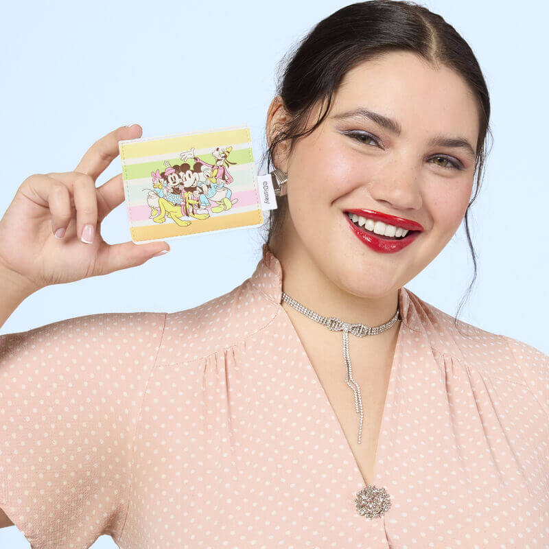 Lifestyle image of the Loungefly Disney Mickey & Friends Rainbow Stripes Card Holder held by a model