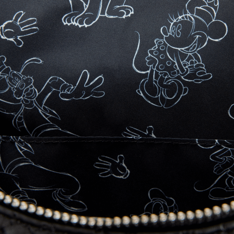 Close up of black Disney sketch lining with white outlines of Mickey, Minnie, Goofy and gloved hands