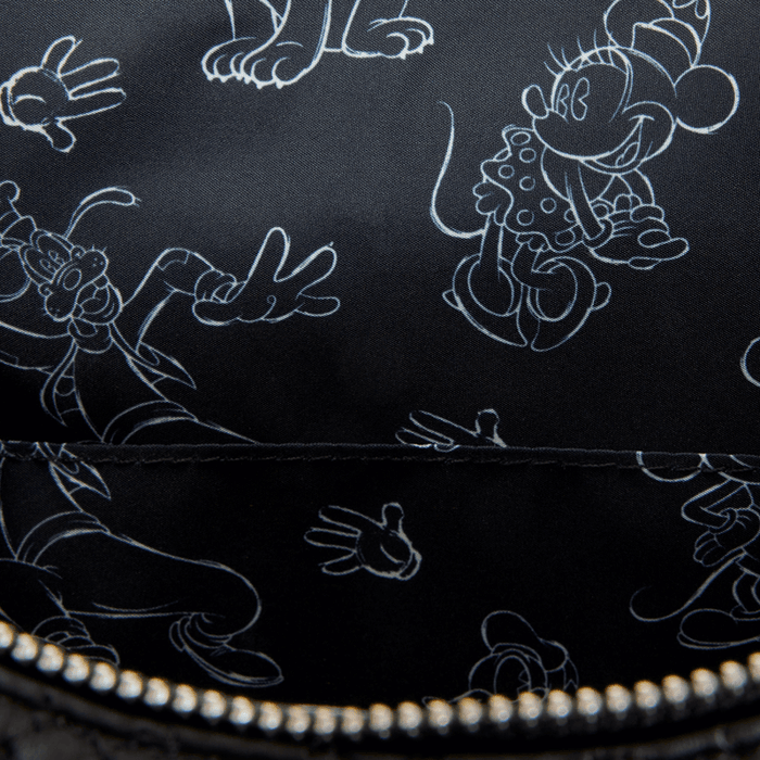 Close up of black Disney sketch lining with white outlines of Mickey, Minnie, Goofy and gloved hands