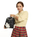 Model holding Loungefly Disney Mickey and Friends black sketch mini backpack by the top handle