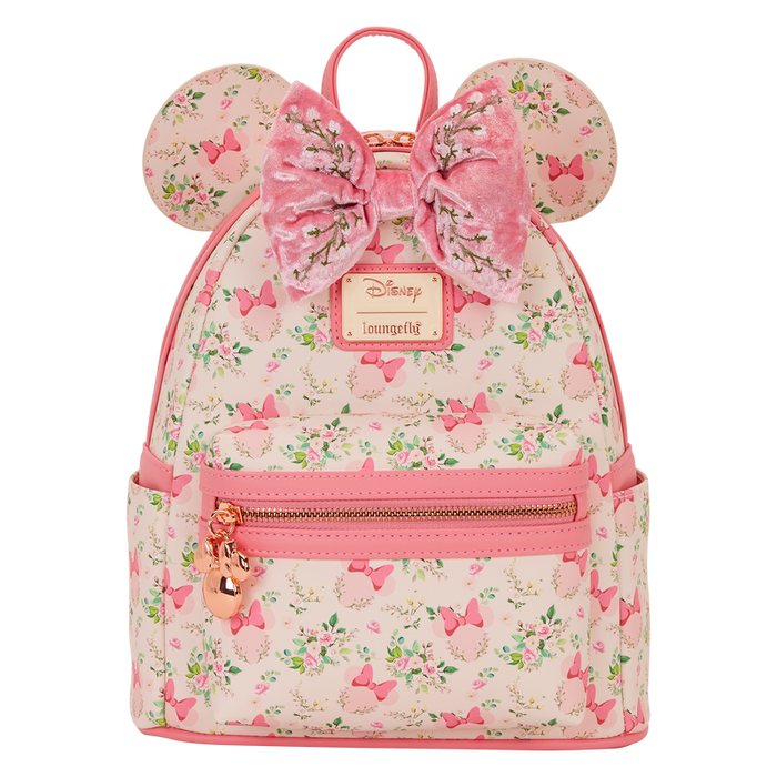 Front view of the Loungefly Disney Minnie Mouse floral mini backpack with Minnie ears, large pink velvet bow and front zip pocket.