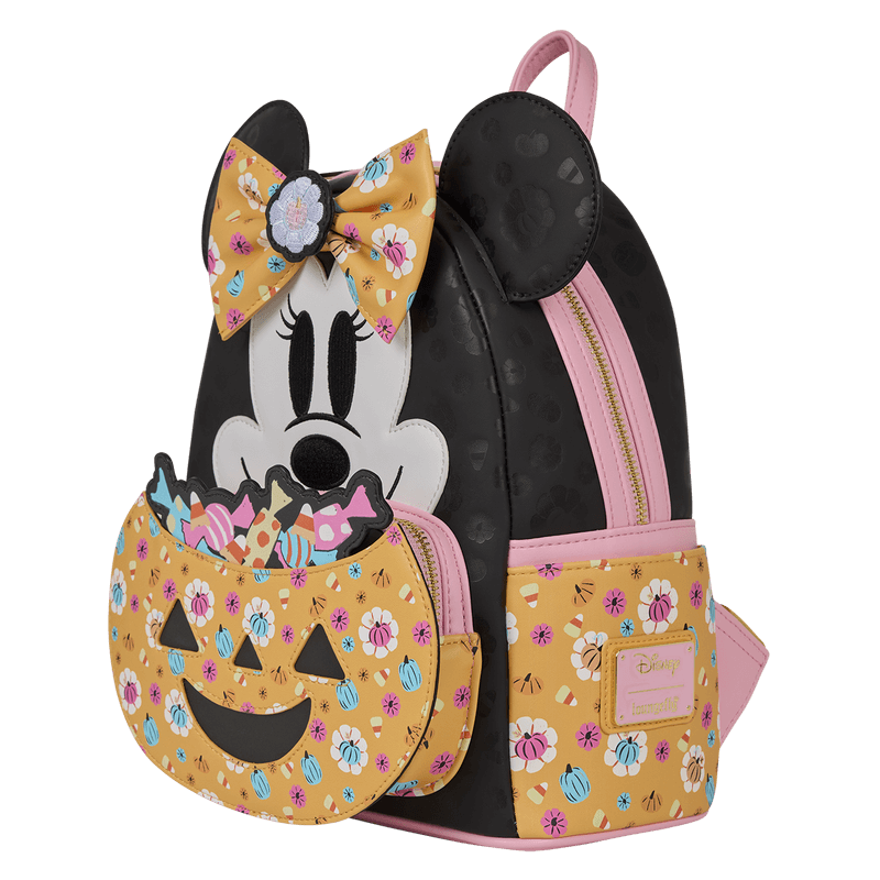 Angled front view of Loungefly Disney Minnie Mouse Halloween mini backpack with jack-o-lantern candy pocket, black body and pink trims