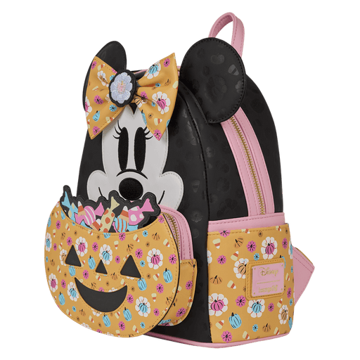 Angled front view of Loungefly Disney Minnie Mouse Halloween mini backpack with jack-o-lantern candy pocket, black body and pink trims