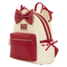 Angled view of the Loungefly Disney Minnie Mouse mini backpack showing the red polka dot bow, gold zip, cream body and red front pocket.
