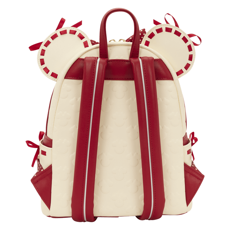 Back view of the Loungefly Disney Minnie Mouse Rocks The Dots mini backpack showing red straps, top handle and embossed Mickey icon pattern.